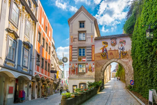 Unteres Burgtor von Schloss Lamberg mit einer Darstellung der mittelalterlichen Burg. Klicke hier um auf die Seite Veranstaltungen in Steyr zu wechseln